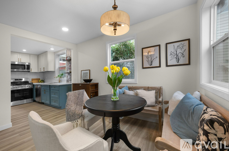 A living room with a dining table and chairs.