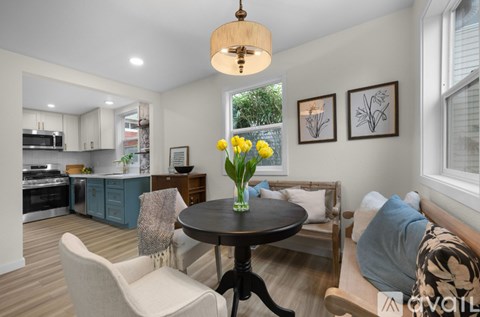 A living room with a dining table and chairs.