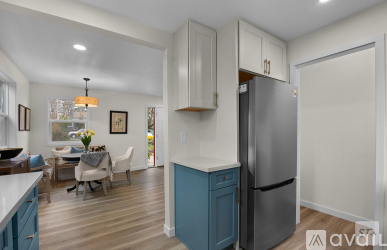 A bathroom with a white sink and a mirror above it.