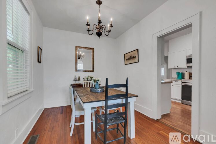 A dining room with a wooden table and chairs.