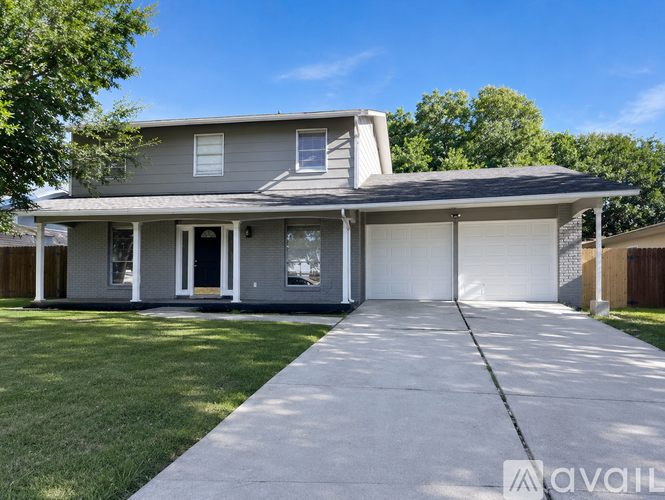 A house with a grey roof and a white garage door.