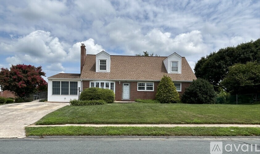 A house with a brown roof and white trim is for sale.
