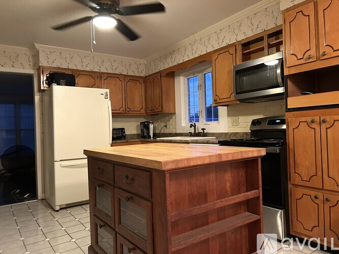 A kitchen with wooden cabinets and a white refrigerator.