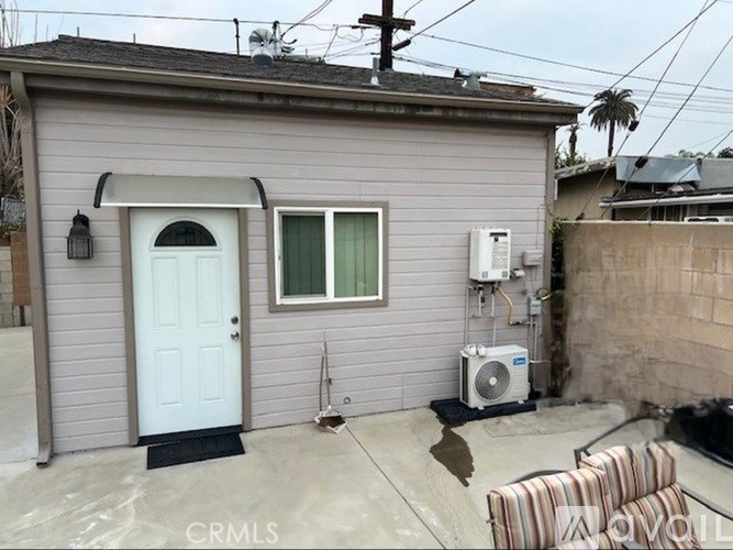 A house with a white door and a window with a curtain.