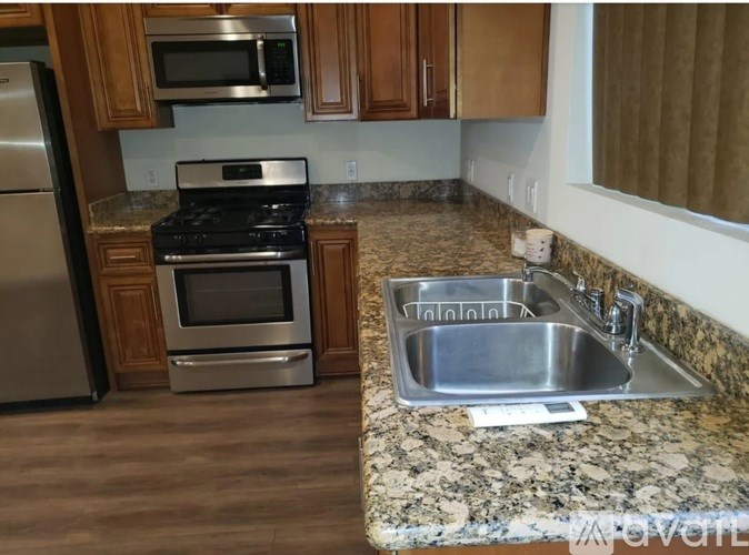 A kitchen with granite countertops and stainless steel appliances.