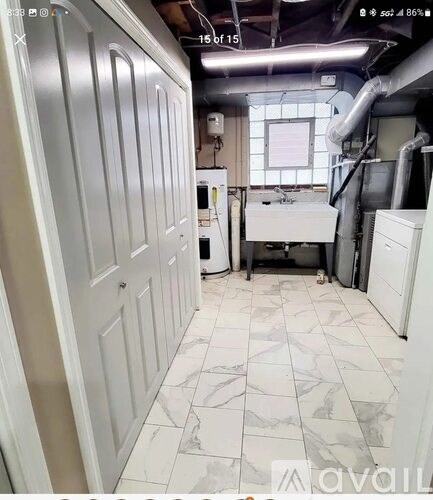 A kitchen with white cabinets and a white countertop.