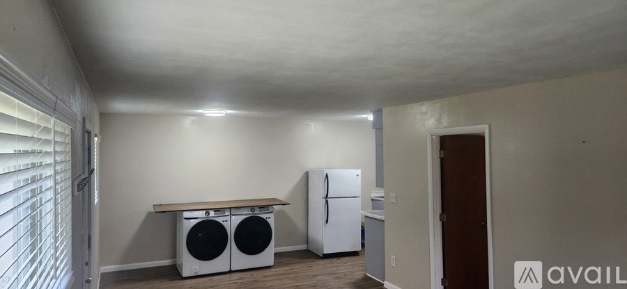 A kitchen area with a white fridge and a wooden countertop.
