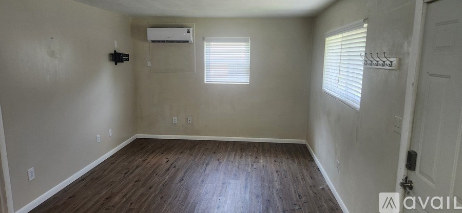 A room with wooden floors and a white door.