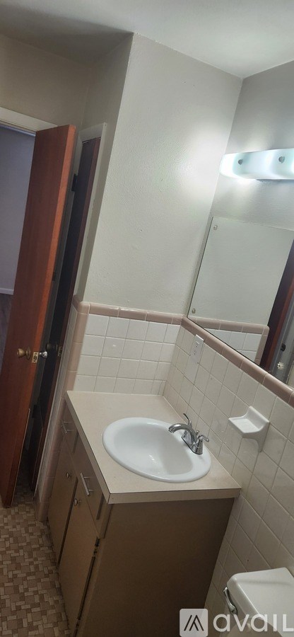 A bathroom with a sink and a mirror.