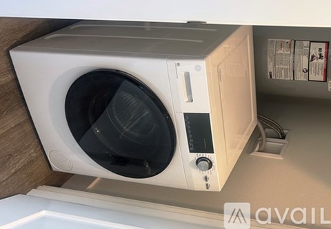 A washing machine is placed in a kitchen.