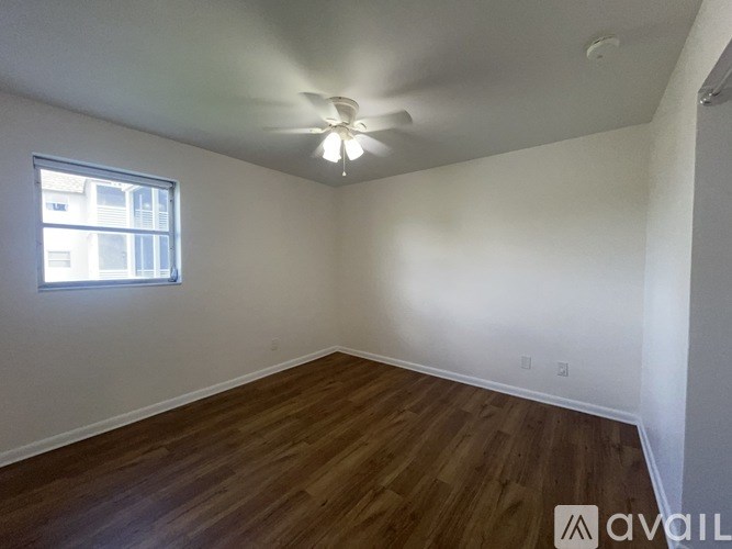 A room with a ceiling fan and a window.