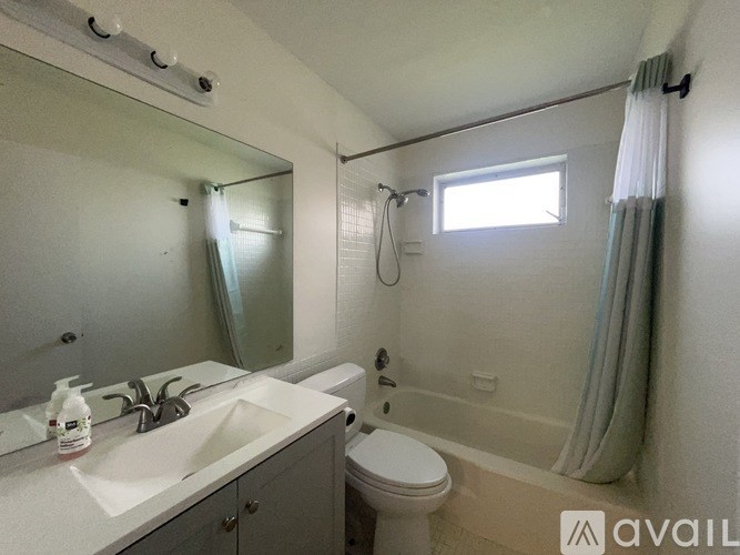 A bathroom with a sink, toilet, and bathtub.