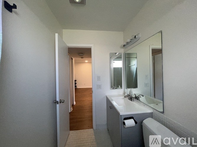 A bathroom with a white sink and a mirror above it.