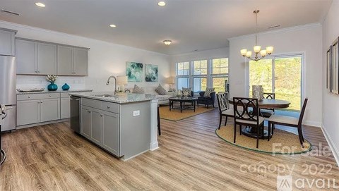 A kitchen with a dining table and chairs is for sale.