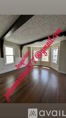 A room with wooden floors and a text overlay.