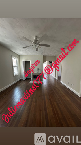 A room with wooden floors and a ceiling fan.