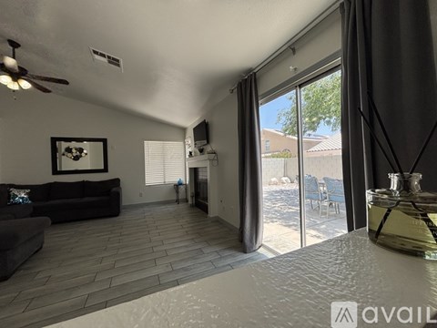 A living room with a black couch and a flat screen TV.