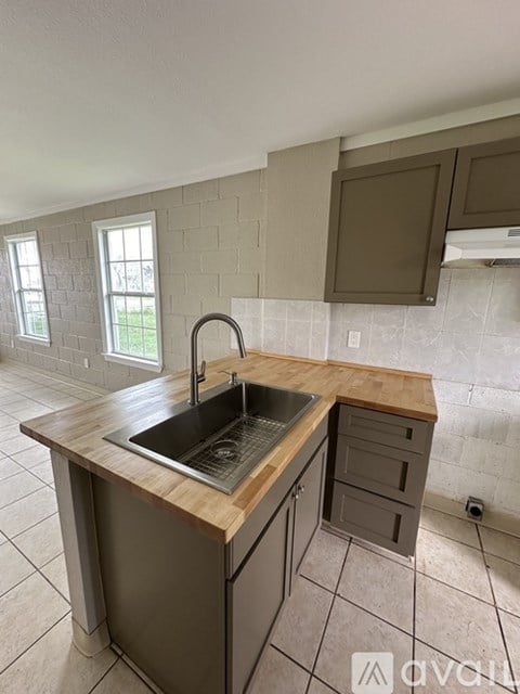 A kitchen with a sink and a window.