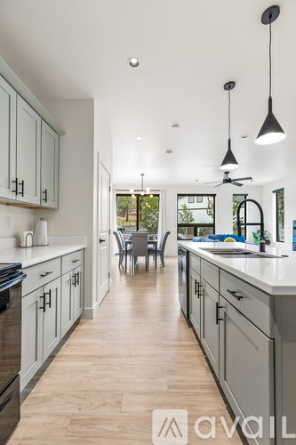 A modern kitchen with a long counter and cabinets.