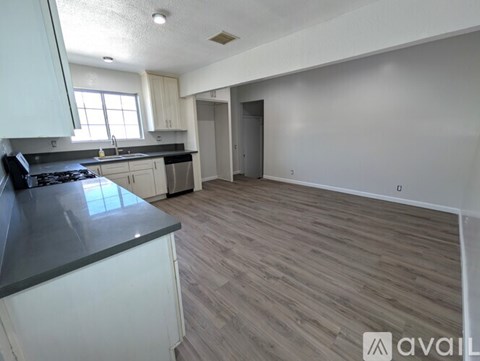 A kitchen with a stove top oven and a counter top.