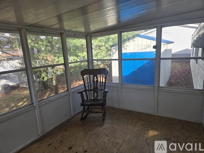 A chair is placed in a room with a window.