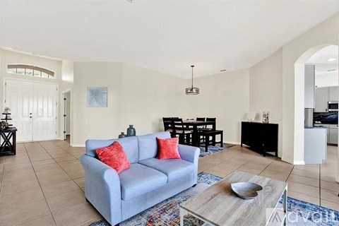 A living room with a grey couch and a coffee table.