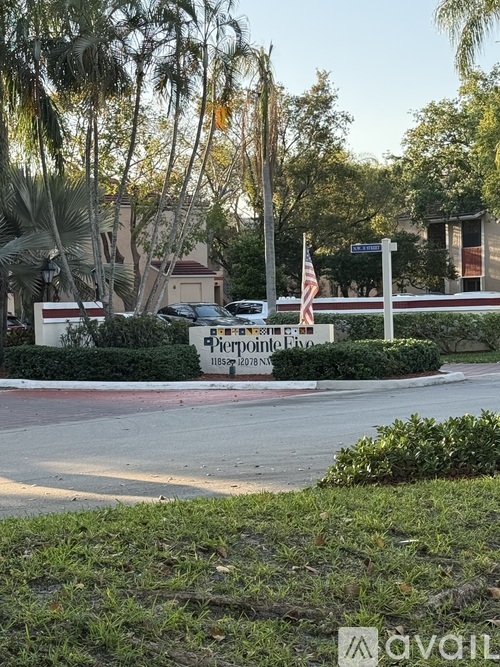 A sign for Pierpoint Estates is in front of a building and trees.
