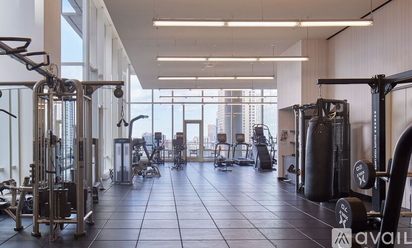 A gym with a view of the city outside the windows.