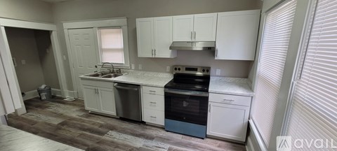 A kitchen with a white counter top and a blue stove top oven.
