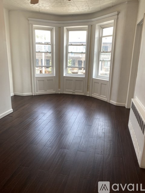 A room with wooden floors and white walls.
