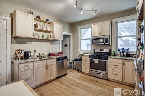 A kitchen with wooden cabinets and stainless steel appliances.