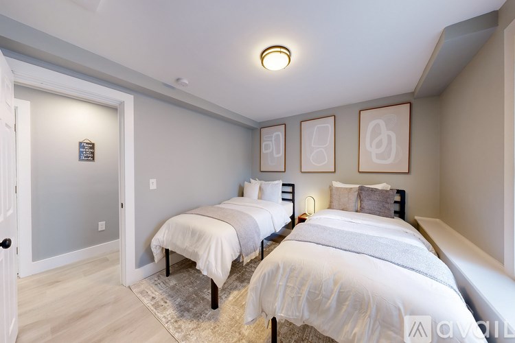 A bedroom with two beds and a door.