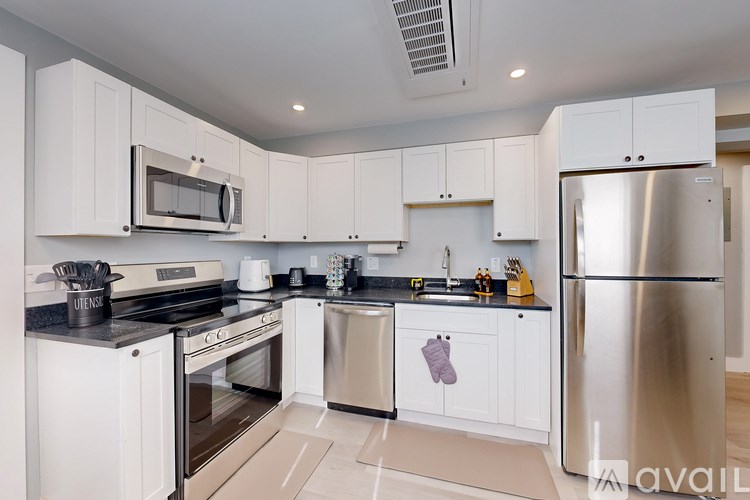 A kitchen with white cabinets and stainless steel appliances.