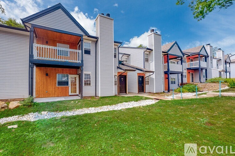 A row of houses with a grassy area in front.