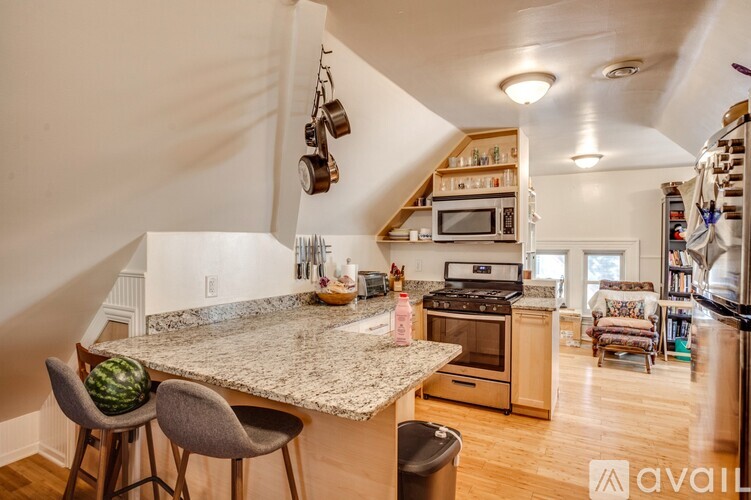 A kitchen with granite countertops and a stainless steel oven.