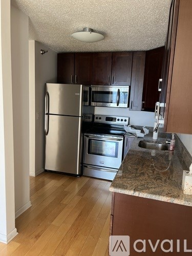 A kitchen with a stainless steel refrigerator and oven.