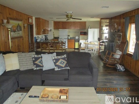 A living room with a grey couch and a wooden coffee table.