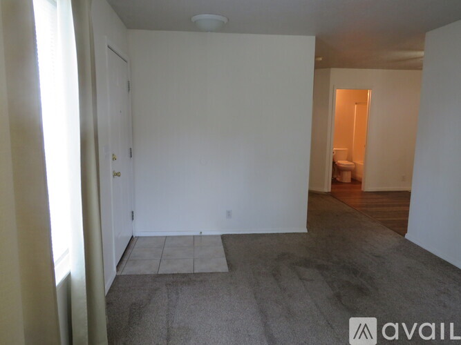 A room with a carpeted floor and white walls.