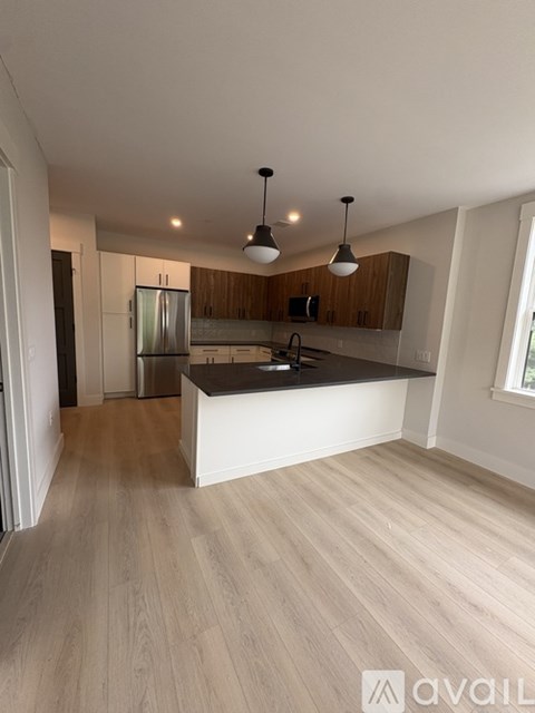 A kitchen with wooden cabinets and a white island.