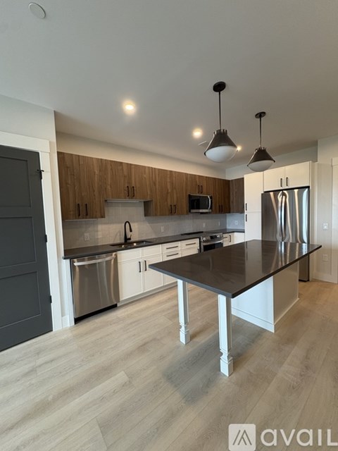 A modern kitchen with a large island in the center.