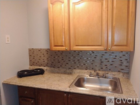 A kitchen with wooden cabinets and a granite countertop.