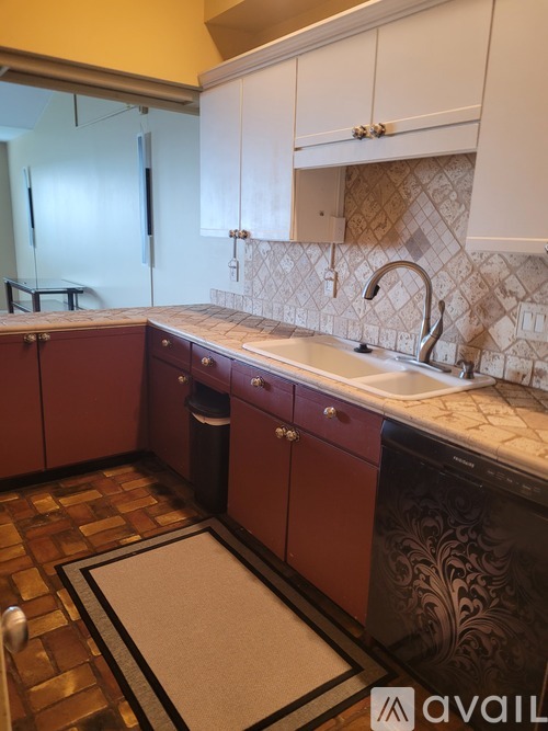 A kitchen with a sink and a dishwasher.