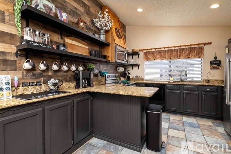 A kitchen with wooden walls and a granite countertop.