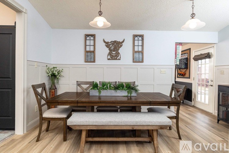 A wooden dining table with chairs and a bench in a room.