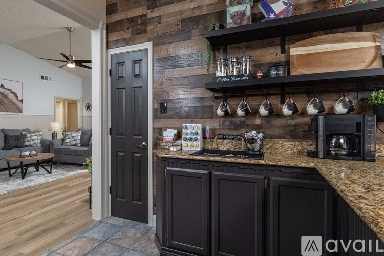 A kitchen with a dark wood finish and a black door.