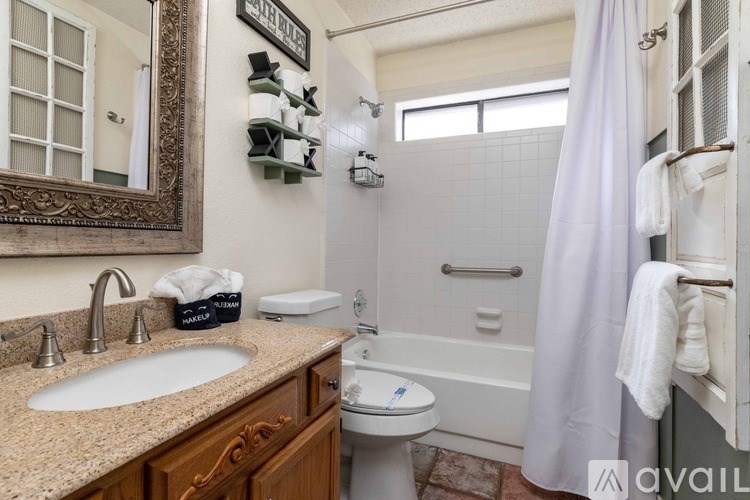 A bathroom with a sink, toilet, and bathtub.