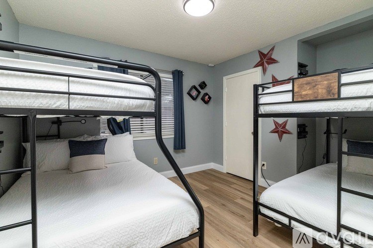 A room with bunk beds and a red star on the wall.