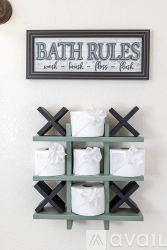 Bathroom rules sign and toilet paper holder.