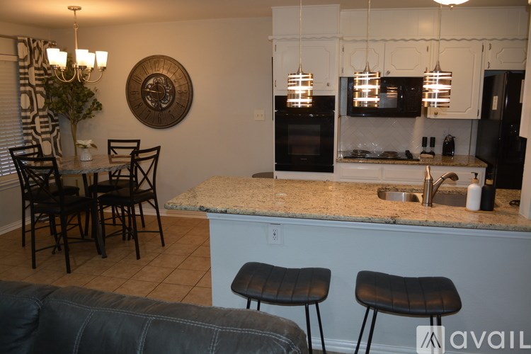 A kitchen with a granite countertop and a large island.