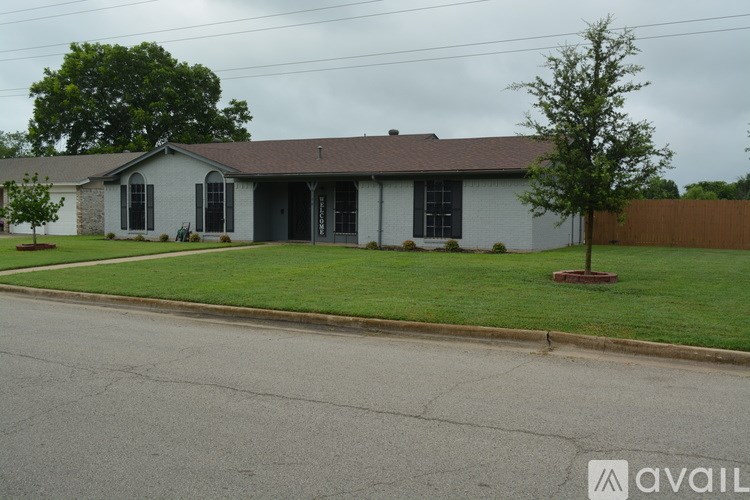 A house with a grey roof and a green lawn.